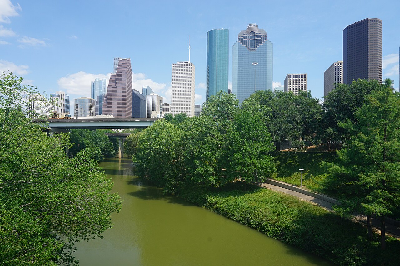 Buffalo Bayou with downtown Houston towers beyond a bridge