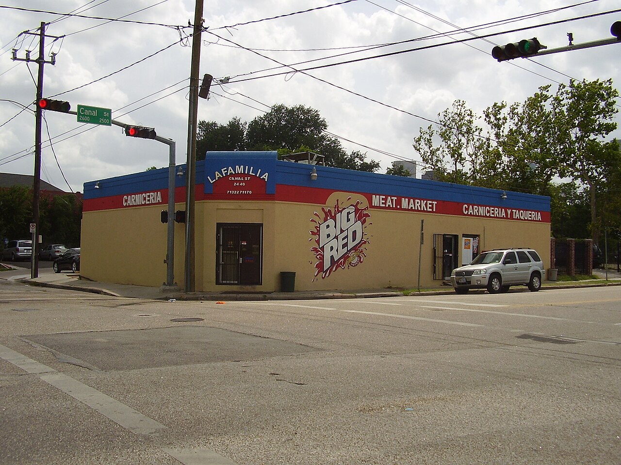 Corner store painted La Familia carnceria and meat market on Canal Street