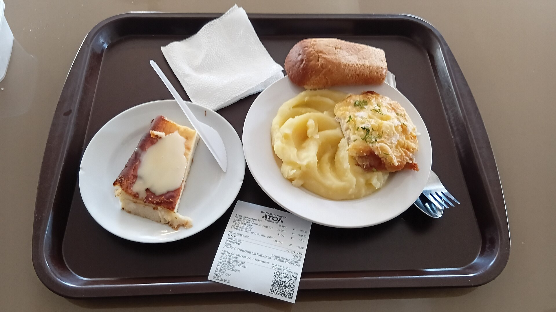 Cafeteria tray with mashed potatoes, a roll, and cake